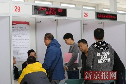 應聘者現場咨詢工作崗位及工資情況。